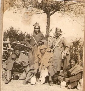 A group of five soldiers smiling at the camera