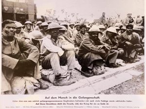 A group of seated soldiers looking at the camera